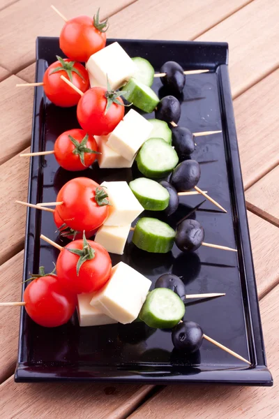 Appetizers with cheese,tomato,cucumber and olive — Stock Photo, Image