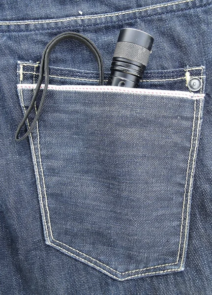Flashlight in the back pocket of jeans — Stock Photo, Image