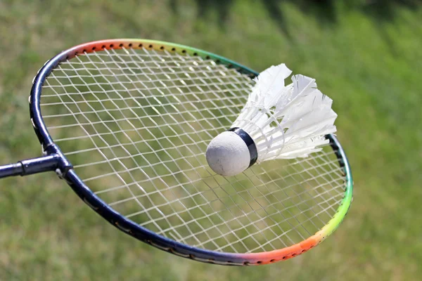 Badminton shuttlecocks on racket — Stok fotoğraf