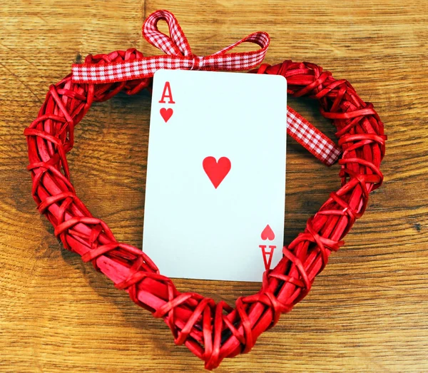 Red heart on a board with an ace heart — Stock Photo, Image