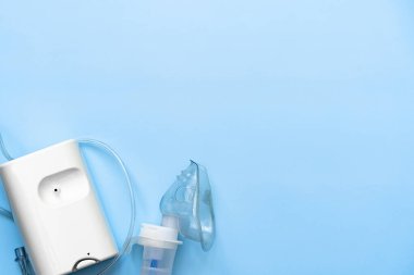 Mavi arkaplanda astım spreyi, metin için boşluk, üst görünüm, düz uzanma 