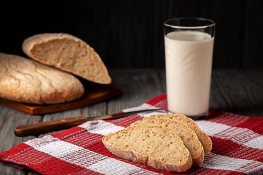 Freshly baked homemade bread with a glass of milk on the table