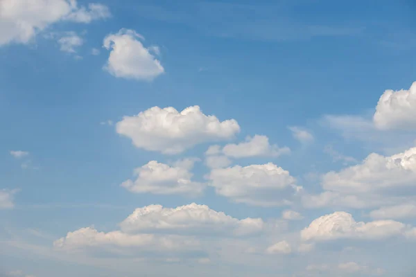 Rare cumulus clouds against a clear blue sky - Stok İmaj