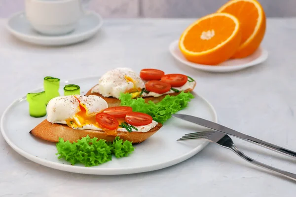 Healthy food concept. Poached egg toast with tomato and cream cheese and bread on a plate.
