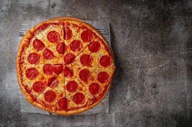 Fresh delicious Italian pizza on a gray stone table background