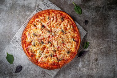 Fresh delicious Italian pizza on a gray stone table background