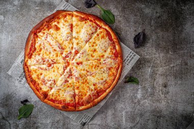 Fresh delicious Italian pizza on a gray stone table background