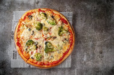 Fresh delicious Italian pizza on a gray stone table background