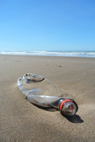 Botella de plástico contaminando la playa —  Fotos de Stock