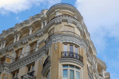 Madrid, İspanya 'da Gran Via caddesindeki bej klasik binanın köşesi.