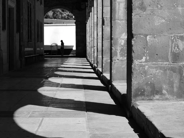 Tunnel with light and shadow on the territory of catholic church in Legazpi, Basque Country, Spain. Black and white photo.