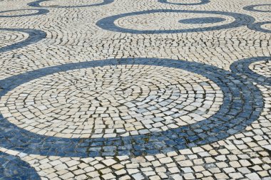 Vintage pavement made out of cobblestone outside on the street downtown Aveiro, Portugal.