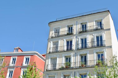Classical residential houses with retro windows and shutters downtown district of Madrid, Spain.