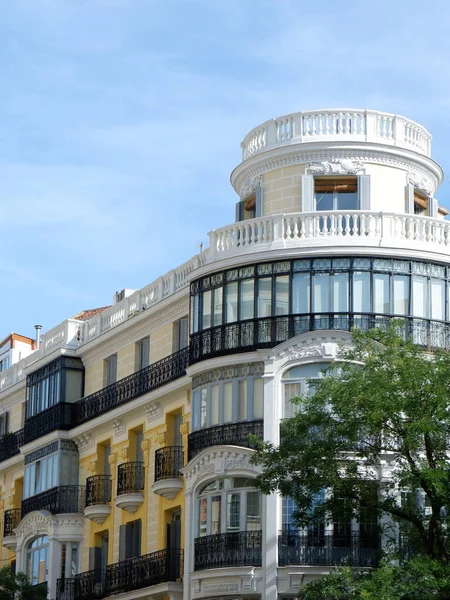 Rounded corner of elegant classical building in Fuencarral district downtown Madrid, Spain. Vertical photo.