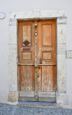 Old shabby door from outside in Arreau town, France. Vintage french architecture.