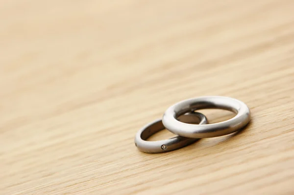 Wedding rings on wood with copy space — Stock Photo, Image