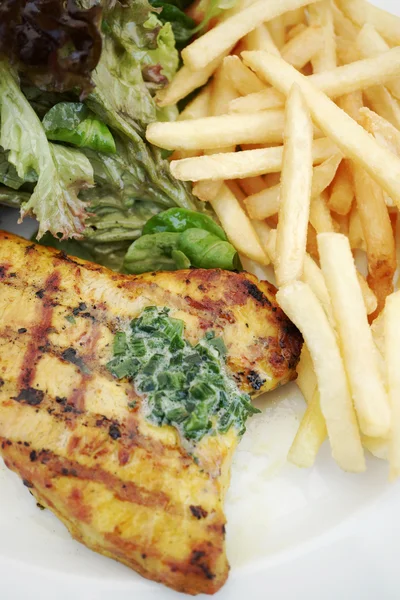 Grilled turkey steak with fries and salad — Stock Photo, Image