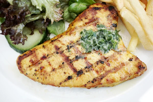 Grilled turkey steak with fries and salad — Stock Photo, Image