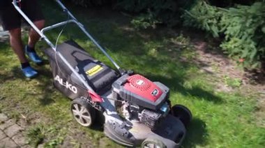 Bahçıvan çimleri benzin çim biçme makinesiyle biçiyor, 11 Eylül 2021, Ternopil, Ukrayna