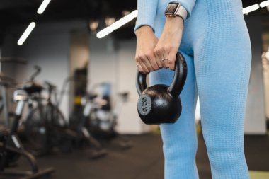 Kettlebell tutan kadın. Yakından.