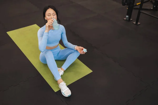 Sportive Woman Drinking Water Bottle While Sitting Mat Gym Floor — 图库照片