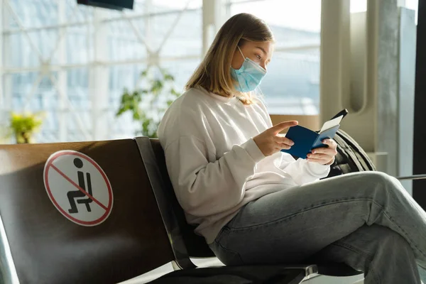 Female Tourist Mask Sitting Airport Terminal Lounge Empty Marked Chairs — Stockfoto