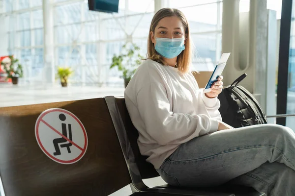 Woman Tourist Mask Flight Tickets Sitting Socially Distanced Chair Airport — Stockfoto