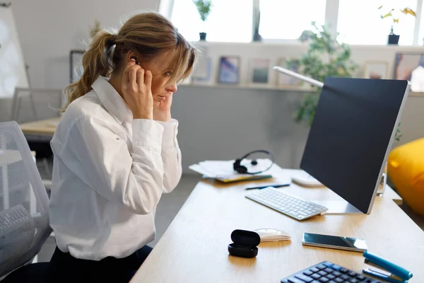 Mature Businesswoman Putting Wireless Headphones Online Meeting — Zdjęcie stockowe