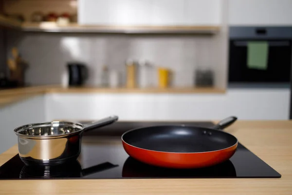Frying pan and sauce pan on modern induction cooktop