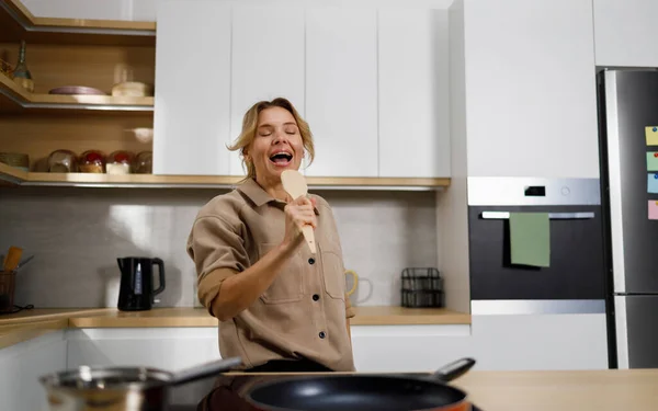 Happy Adult Woman Singing Wooden Spatula Kitchen — Stock Photo, Image