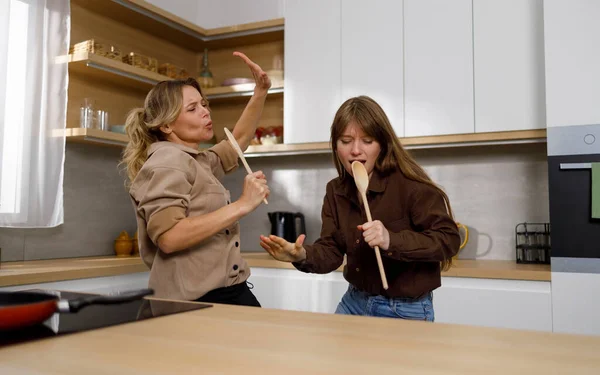 Two Females Cooking Together Dancing Sing Spatulas Microphone Mom Daughter — Stock Photo, Image