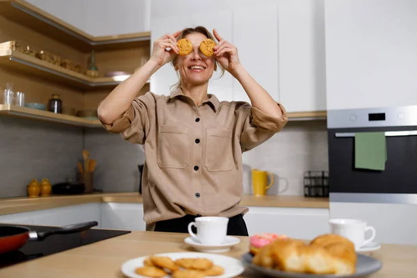 Beautiful Blonde Woman Holding Cookies Eyes Female Having Fun Kitchen — Stock Photo, Image