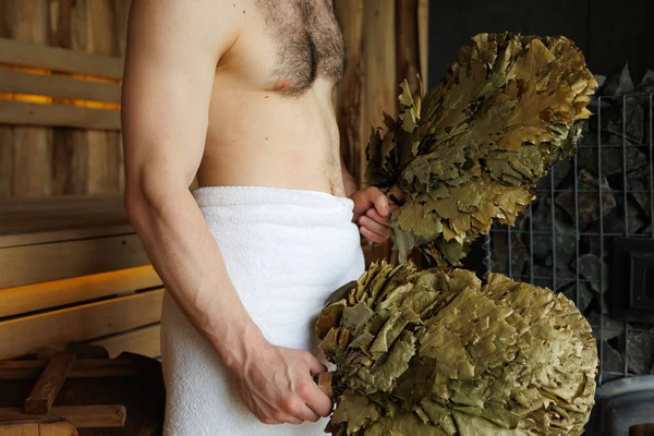 Naked Man Wrapped Towel Sauna Brooms His Hands While Resting — стоковое фото