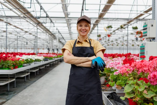 Cheerful Female Flowers Greenhouse Worker Holding Protective Gloves Her Hands — Stockfoto