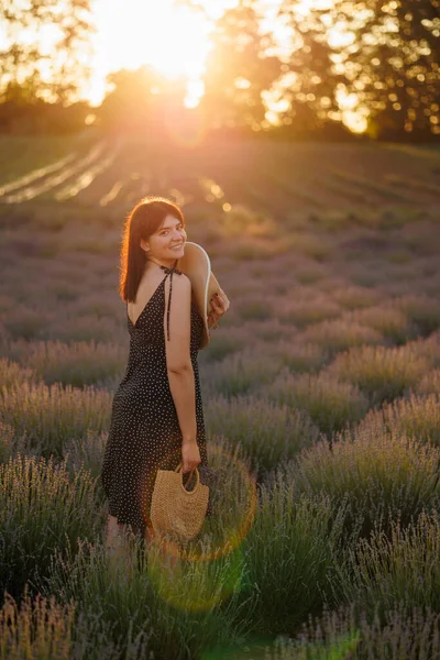 Beautiful woman in lavender field at sunset