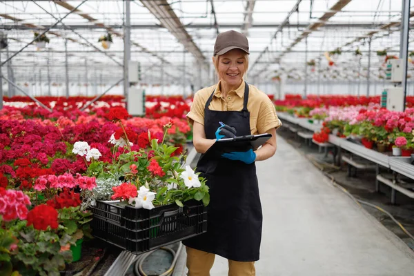 Woman Fills Out Inspection Document Greenhouse Flowers — Stock Fotó