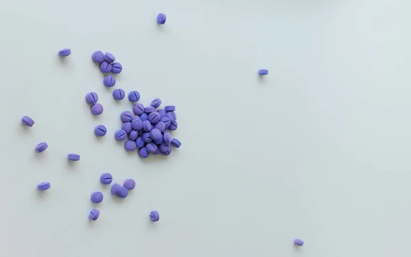 Scattered blue pills on a white background. Dental plaque detection tool