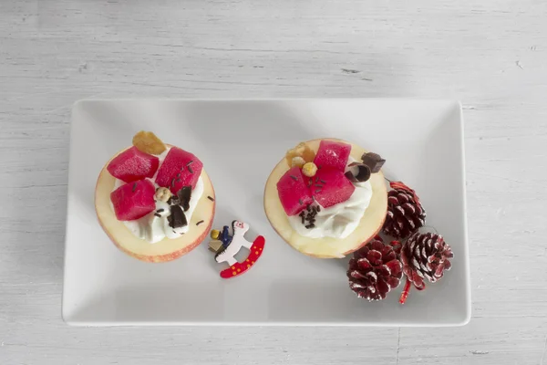 Apples stuffed with cream and fruit on white plate — Stock Photo, Image