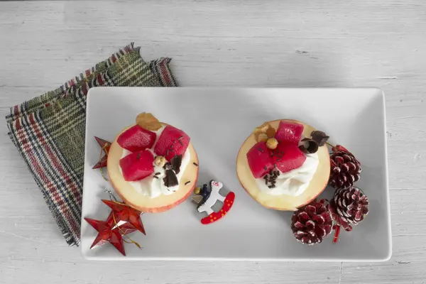 Apples stuffed with cream and fruit on white plate — Stock Photo, Image