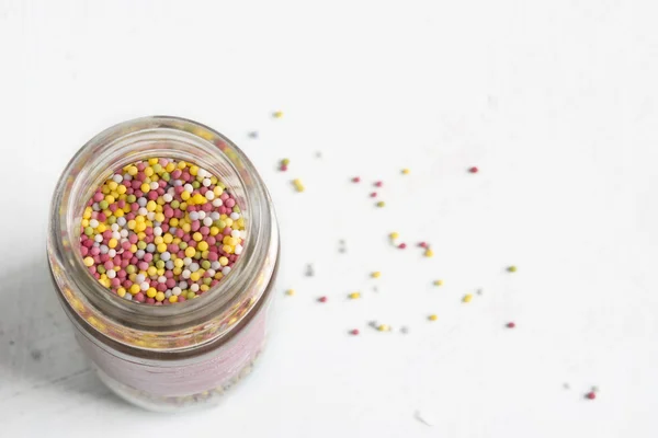 A lot of sprinkles, in glass jar — Stock Photo, Image