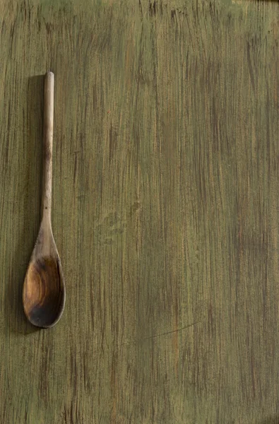 Wooden kitchenware on green background — Stock Photo, Image