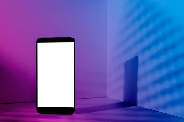 Minimalist modern smartphone mockup for presentation, in perspective in front of the corner angle of the wall, with overlapping shadows and gradient holographic colors. application display, information or graphics