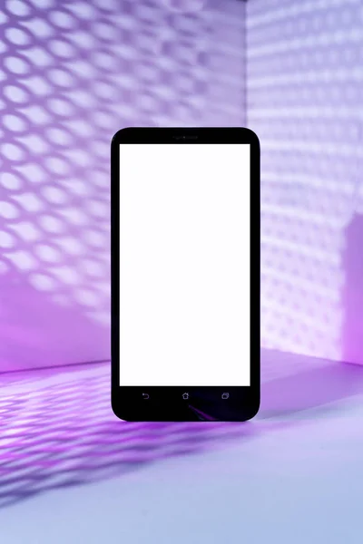 Minimalist modern smartphone mockup for presentation, front of the corner angle of the wall, with overlapping shadows and purple gradient holographic colors. application display, information or graphics