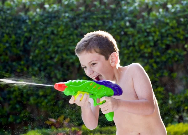 Kid playing with water toys in backyard. — Stock Photo, Image