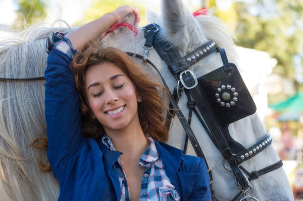 Женщина улыбается с лошадью — стоковое фото