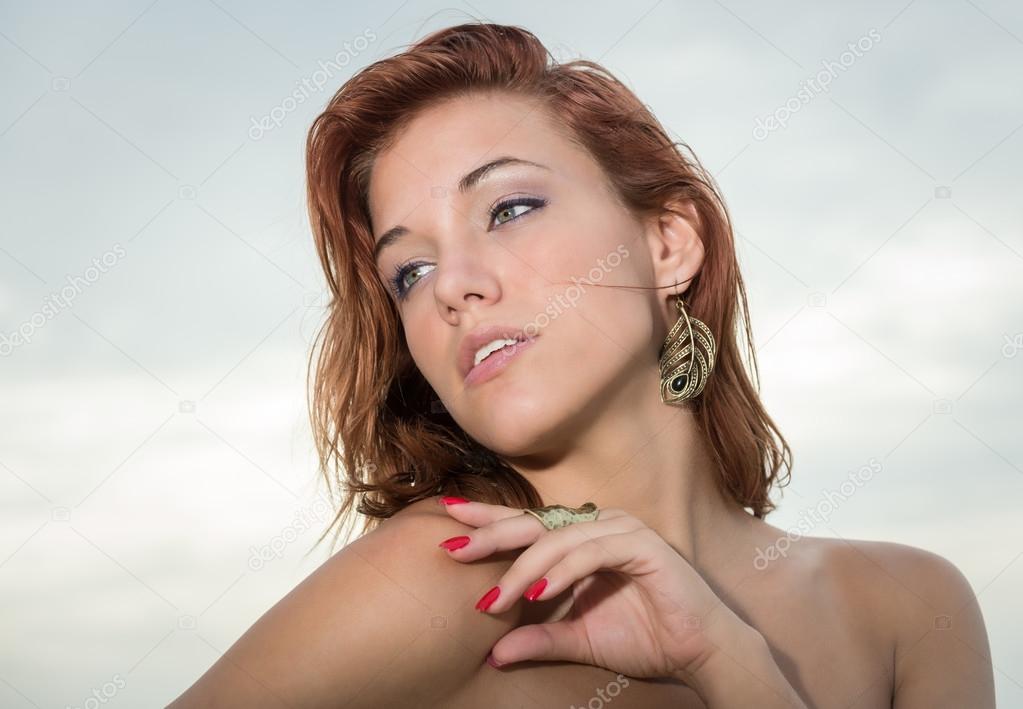 Young red head woman looking away