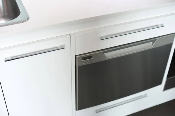 Modern white fan oven with a glass fronted door in a fitted kitchen for cooking the food, close up high angle view