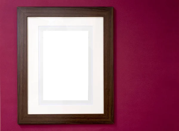 Photo or painting frame in smooth glossy finish with blank area for copy space or image over dark red wall