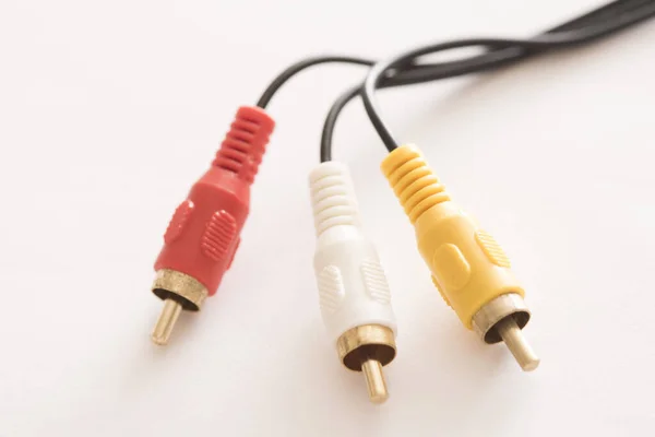 Close-up view of RCA cable connector for video and two audio stereo channels on white background