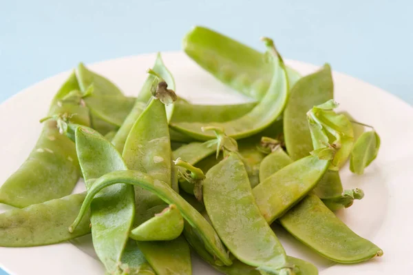 Fresh sugarsnap peas, snow peas or mangetout, a vegetarian delicacy with their crisp green edible pods